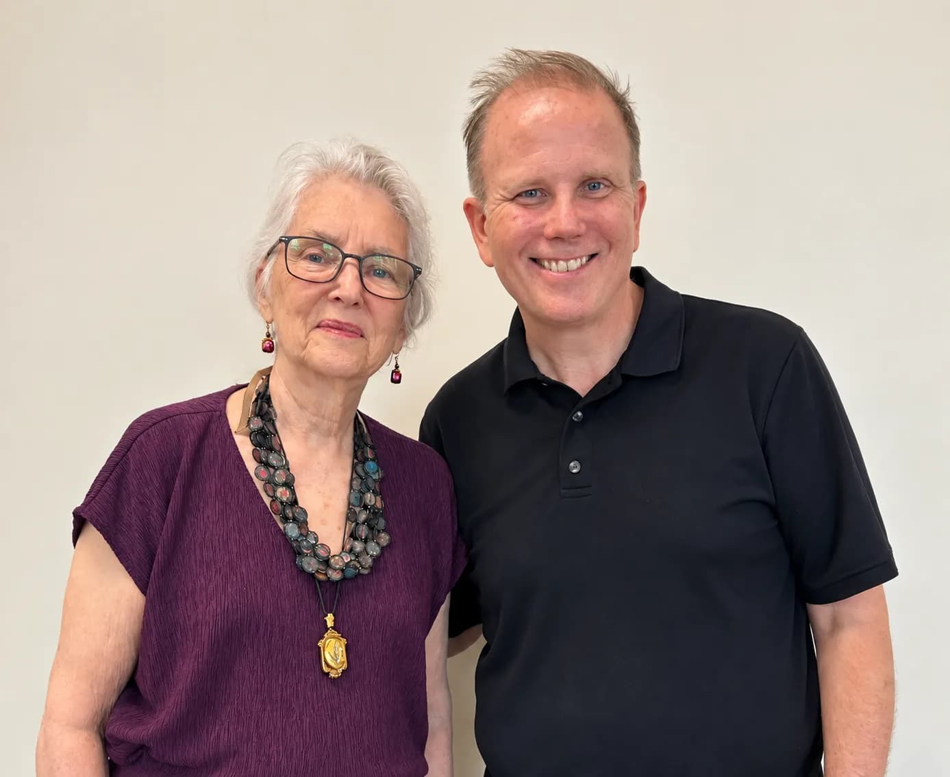 Jamie Parsley and the painter Marjorie Schlossman standing side by side and smiling